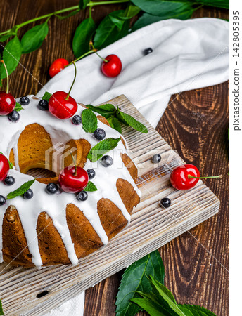 Glazed Bundt Cake with Fresh Fruits and White Icing Glazed Bundt Cake with Fresh Fruits and White Icing 142805395