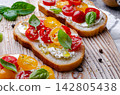 Bruschetta with Cream Cheese, Fresh Tomatoes and Basil 142805438