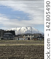 Snow-covered Mount Iwate and rural landscape 142805490