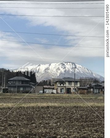 Snow-covered Mount Iwate and rural landscape Snow-covered Mount Iwate and rural landscape 142805490