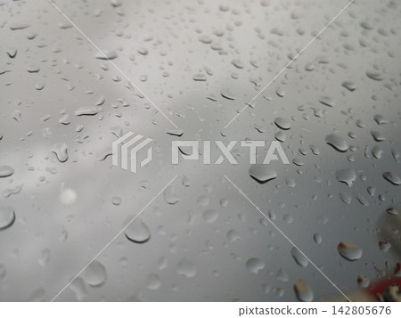 rain drops on car window rain drops on car window 142805676