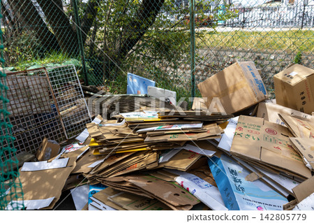 Cardboard boxes for recyclable waste piled high at the garbage collection point. Cardboard boxes for recyclable waste piled high at the garbage collection point. 142805779