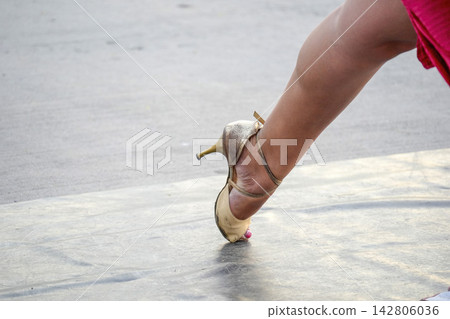 Woman Dancing Tango in High Heel Shoes on Outdoor Stage Woman Dancing Tango in High Heel Shoes on Outdoor Stage 142806036