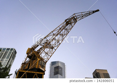 Vintage Yellow Port Crane Against Blue Sky in Puerto Madero Vintage Yellow Port Crane Against Blue Sky in Puerto Madero 142806051