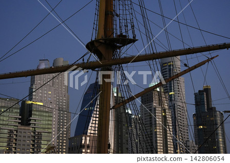 Tall Ship Mast and Rigging Against Buenos Aires Skyline at Dusk Tall Ship Mast and Rigging Against Buenos Aires Skyline at Dusk 142806054