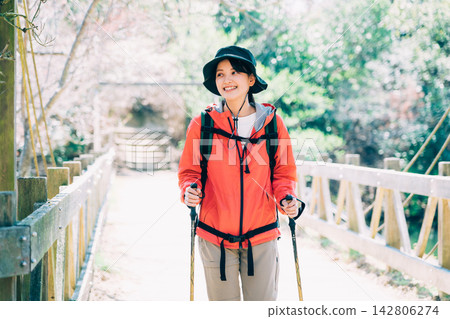 A woman trekking A woman trekking 142806274