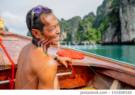 Thai boatman smiling enjoying longtail boat ride Thai boatman smiling enjoying longtail boat ride 142806580