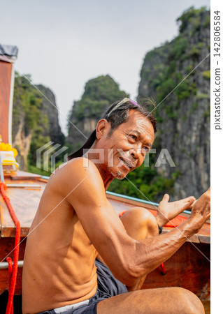 Thai man longtail boat captain working in thailand Thai man longtail boat captain working in thailand 142806584