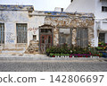 Weathered Traditional Building and Flower Display on Syros, Greece 142806697