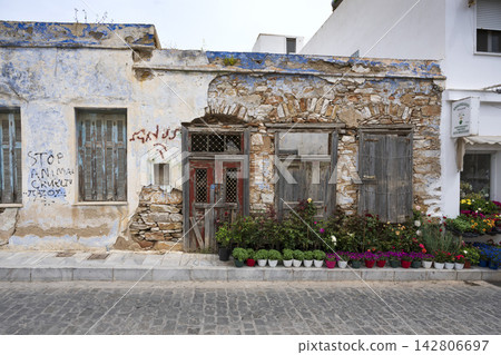 Weathered Traditional Building and Flower Display on Syros, Greece Weathered Traditional Building and Flower Display on Syros, Greece 142806697