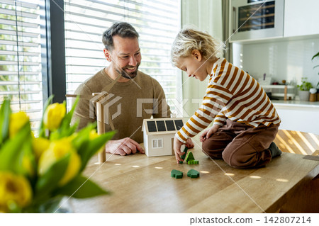 Father educating toddler about solar power and eco friendly living. Father educating toddler about solar power and eco friendly living. 142807214