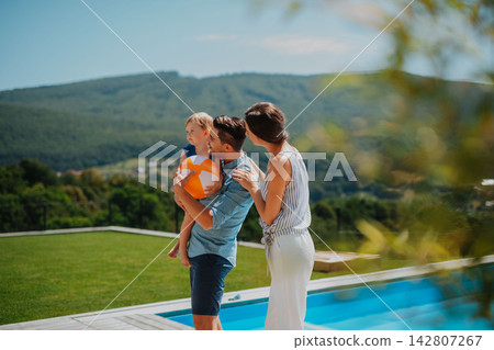 Joyful family moment in backyard with child Joyful family moment in backyard with child 142807267