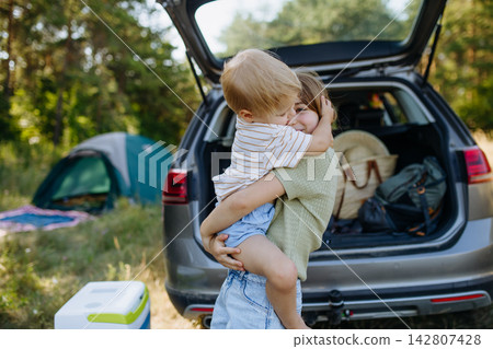 Family getting camping equipment from car after arriving in nature. 142807428