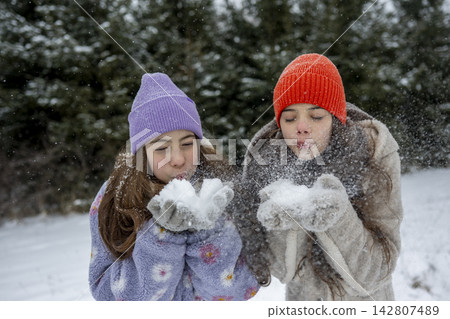 Sisters playing in snow. Winter excitement. Sisters playing in snow. Winter excitement. 142807489