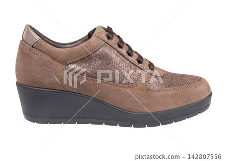 Beige brown suede women lace up wedge sneakers isolated on white background Beige brown suede women lace up wedge sneakers isolated on white background 142807556
