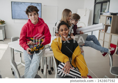 Diverse group of high school students with robotics project in classroom. Diverse group of high school students with robotics project in classroom. 142807592