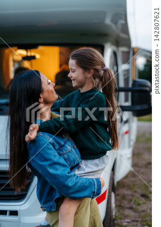 Mother with daughter enyoing family holiday with camper and caravan. Mother with daughter enyoing family holiday with camper and caravan. 142807621