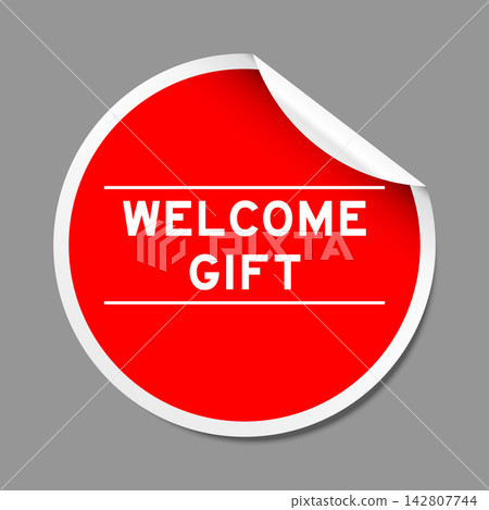 Red color peel sticker label with word welcome gift on gray background 142807744