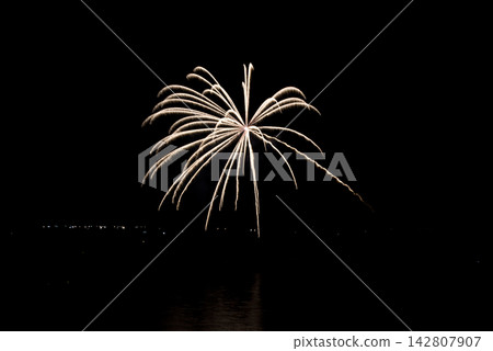 A night view of Shirahama Beach in Wakayama Prefecture. Fireworks are reflected on the sea surface. A night view of Shirahama Beach in Wakayama Prefecture. Fireworks are reflected on the sea surface. 142807907