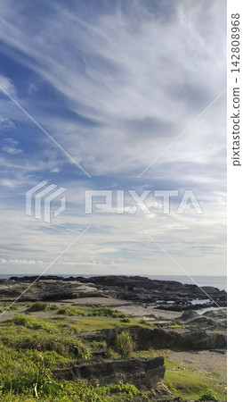 Blue sky and clouds spread out among the rocky shoreline. Blue sky and clouds spread out among the rocky shoreline. 142808968