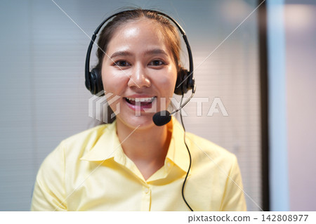 Smiling Customer Service Representative Wearing Headset Smiling Customer Service Representative Wearing Headset 142808977