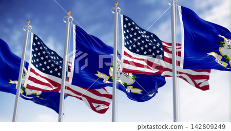 Connecticut state flags waving with national american flags on a clear day. Connecticut state flags waving with national american flags on a clear day. 142809249