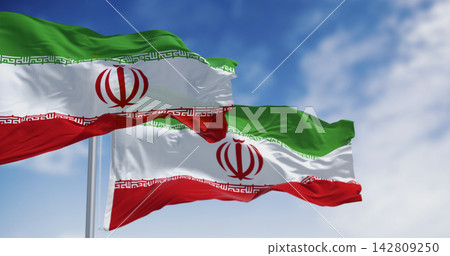National flags of Iran waving in the wind on a clear day 142809250