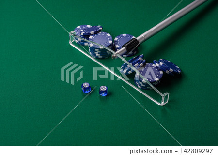 Dice and chips on a green felt gaming table, a poker game in a casino. Casino dice 142809297