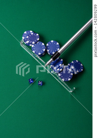 Dice and chips on a green felt gaming table, a poker game in a casino. Casino dice Dice and chips on a green felt gaming table, a poker game in a casino. Casino dice 142809299