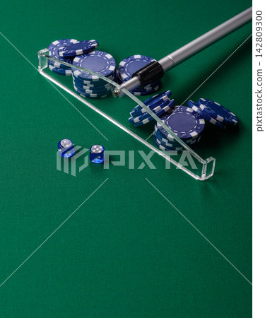 Dice and chips on a green felt gaming table, a poker game in a casino. Casino dice Dice and chips on a green felt gaming table, a poker game in a casino. Casino dice 142809300