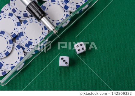Dice and chips on a green felt gaming table, a poker game in a casino. Casino dice Dice and chips on a green felt gaming table, a poker game in a casino. Casino dice 142809322