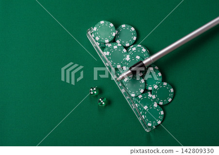Dice and chips on a green felt gaming table, a poker game in a casino. Casino dice Dice and chips on a green felt gaming table, a poker game in a casino. Casino dice 142809330