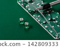 Dice and chips on a green felt gaming table, a poker game in a casino. Casino dice 142809333