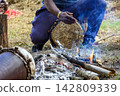 Drum being played beside a bonfire 142809339