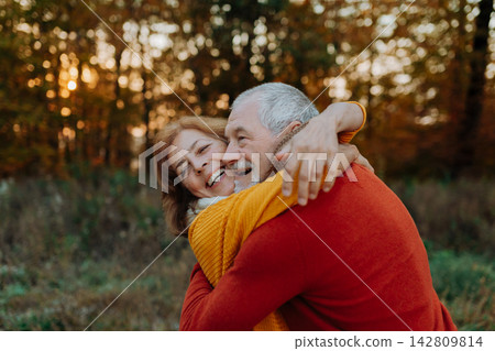 Romantic moment between senior couple, standing in autumn nature. Romantic moment between senior couple, standing in autumn nature. 142809814