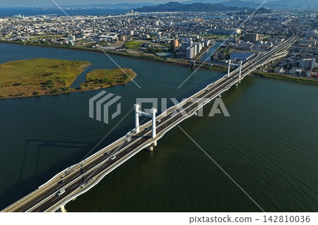 Aerial photograph capturing a cable-stayed bridge and the surrounding Yoshino River area in Tokushima City, Tokushima Prefecture. 142810036