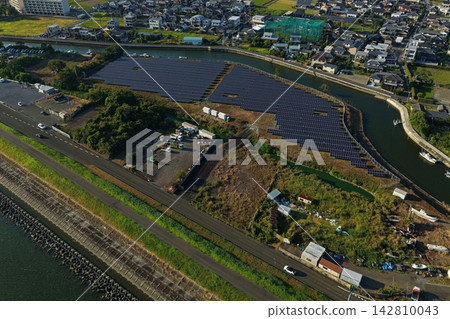 Aerial photograph capturing a residential area along a river in Tokushima City, Tokushima Prefecture, and solar panels. Aerial photograph capturing a residential area along a river in Tokushima City, Tokushima Prefecture, and solar panels. 142810043