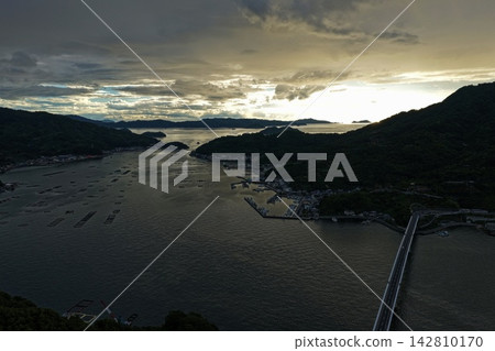 Aerial photographs capturing the bay, islands, and aquaculture rafts of Uwajima City, Ehime Prefecture. Aerial photographs capturing the bay, islands, and aquaculture rafts of Uwajima City, Ehime Prefecture. 142810170