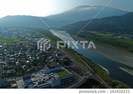 Aerial photograph capturing the Yoshino River, bridge, and residential area in Mima City, Tokushima Prefecture. Aerial photograph capturing the Yoshino River, bridge, and residential area in Mima City, Tokushima Prefecture. 142810222