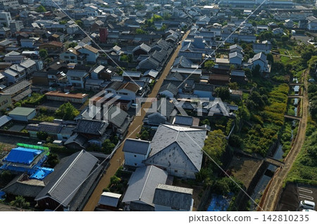 Aerial photograph capturing a residential area and roads muddy with mud in Mima City, Tokushima Prefecture. Aerial photograph capturing a residential area and roads muddy with mud in Mima City, Tokushima Prefecture. 142810235