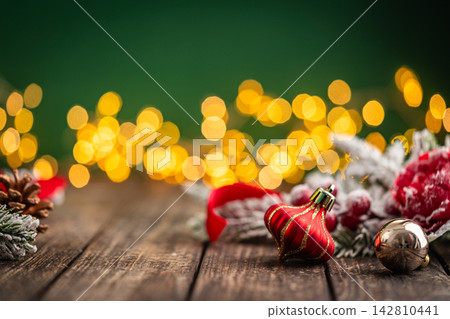 Red Plaid Christmas Ornament with Gold Ribbon on Rustic Wood 142810441