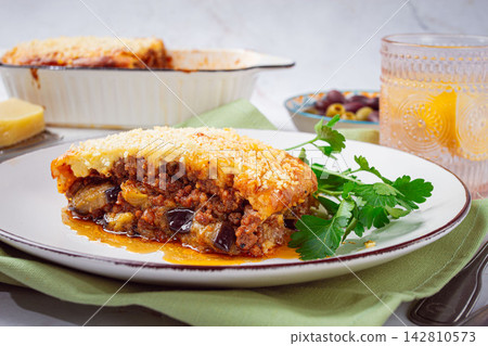 Moussaka served with olives, in a bright kitchen setting, homemade, no people, 142810573