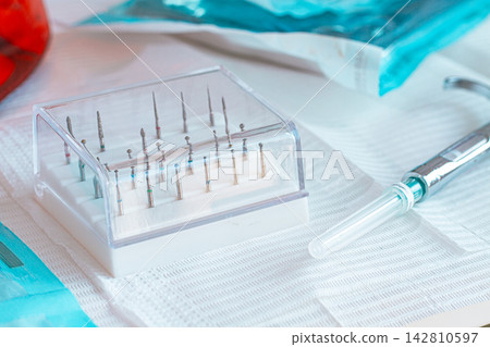 Various instruments, dental models, and hygiene items are laid out on the table in the dental office. natural light Various instruments, dental models, and hygiene items are laid out on the table in the dental office. natural light 142810597