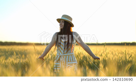 woman walking in a field with open arms woman walking in a field with open arms 142810690