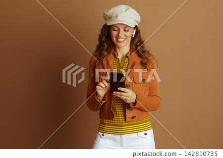Smiling Young Woman with Phone and Autumn Cap Smiling Young Woman with Phone and Autumn Cap 142810735