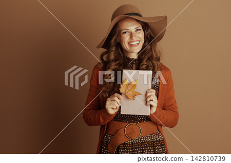 Autumn Serenity with a Book and Maple Leaf Autumn Serenity with a Book and Maple Leaf 142810739