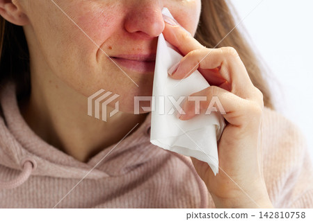 Woman in Pink Hoodie with Nasal Congestion Woman in Pink Hoodie with Nasal Congestion 142810758