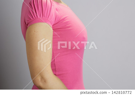 Woman in Pink Shirt Posing for Breast Health Awareness Woman in Pink Shirt Posing for Breast Health Awareness 142810772