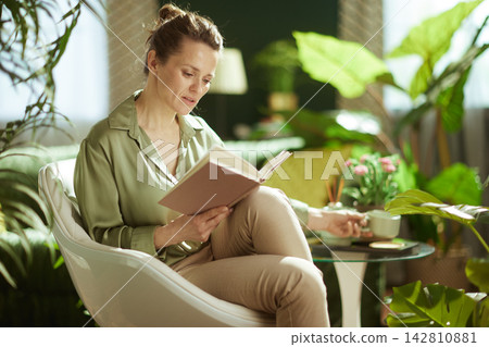 Mindful Reading Session in a Sunlit Plant-Filled Home Mindful Reading Session in a Sunlit Plant-Filled Home 142810881