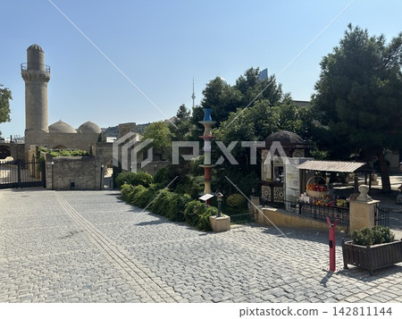Morning market on the square. There are trading tents. Old square with a tent of fruit for sale. 142811144
